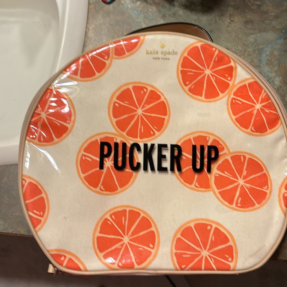 Kate Spade 11” clutch NWT. The only flaw is a small water mark under plastic.